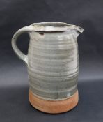 In the style of Hamada Shojii, a stoneware jug with a green glaze 23.