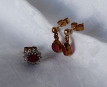 A pair of ruby drop earrings and a single ruby earring, approximately 2.