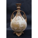 A Royal Worcester twin handled vase with a reticulated flared top above a tear drop shaped body