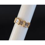 An 18ct yellow gold diamond set ring, set with twelve princess cut diamonds, size N 1/2,