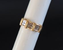 An 18ct yellow gold diamond set ring, set with twelve princess cut diamonds, size N 1/2,