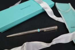 A Tiffany and Co silver ballpoint pen with T clip and turquoise band,