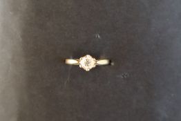 A diamond solitaire ring set with a round old cut diamond approximately 0.