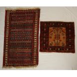 A small red ground rug with multiple stipes to a floral border,