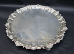 An Edward VII silver salver, with a scrolling leaf cast border on three leaf cast feet, Sheffield,