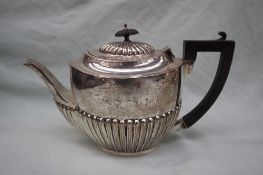 An Edward VII silver teapot, of oval form with a part reeded body, Birmingham, 1906, WA,