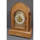 A 19th century rosewood mantle clock, of pointed form, with brass carrying handles,