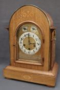 A 19th century rosewood mantle clock, of pointed form, with brass carrying handles,