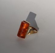 A 9ct gold dress ring set with an amber panel, size P, approximately 6.