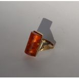 A 9ct gold dress ring set with an amber panel, size P, approximately 6.
