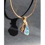 An 18ct yellow gold pendant set with a Queensland boulder opal with three brilliant Cut diamonds on