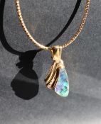 An 18ct yellow gold pendant set with a Queensland boulder opal with three brilliant Cut diamonds on