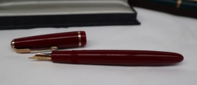 A Parker 51 fountain pen together with three other Parker fountain pens and two boxes