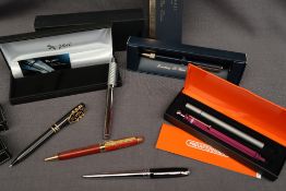 An X-Pen fountain pen together with a Fender wooden pen, a Gibson ballpoint pen,