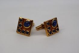 A pair of yellow metal cufflinks,