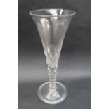 An 18th century oversized wine glass with a trumpet shaped bowl with internal tear drop,