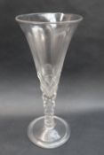 An 18th century oversized wine glass with a trumpet shaped bowl with internal tear drop,