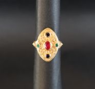 An 18ct yellow gold dress ring, set with a central oval ruby, and sapphires, size P 1/2,