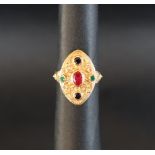 An 18ct yellow gold dress ring, set with a central oval ruby, and sapphires, size P 1/2,