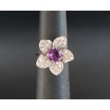 An 18ct white gold amethyst set flower ring, size J 1/2,