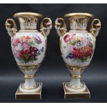 A pair of 19th century porcelain twin handled vases in the Swansea style with a flared top and