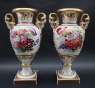 A pair of 19th century porcelain twin handled vases in the Swansea style with a flared top and