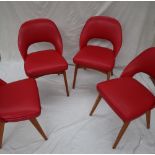 A set of four mid 20th century red vinyl Ben chairs on tapering legs CONDITION REPORT: