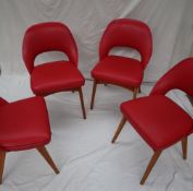 A set of four mid 20th century red vinyl Ben chairs on tapering legs CONDITION REPORT: