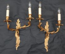 A pair of gilt metal twin branch wall sconces, of scrolling leaf form,