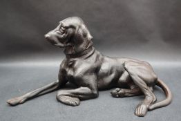 After Nikolai Ivanovich, a cast figure of a recumbent hound with foundry mark and dated 1963,