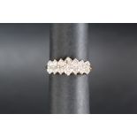A 14ct gold ring set with fourteen round brilliant cut diamonds in two rows, size N,