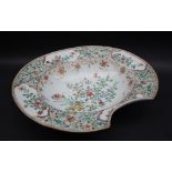 A Chinese porcelain bleeding bowl, decorated to the border with flowers and leaves in vignettes,