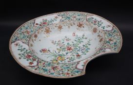 A Chinese porcelain bleeding bowl, decorated to the border with flowers and leaves in vignettes,