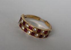 A ruby and diamond two line half eternity ring set with twelve princess cut rubies and twelve round