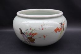 A Chinese porcelain bowl, with a Celadon green glaze painted with figures and a crane,
