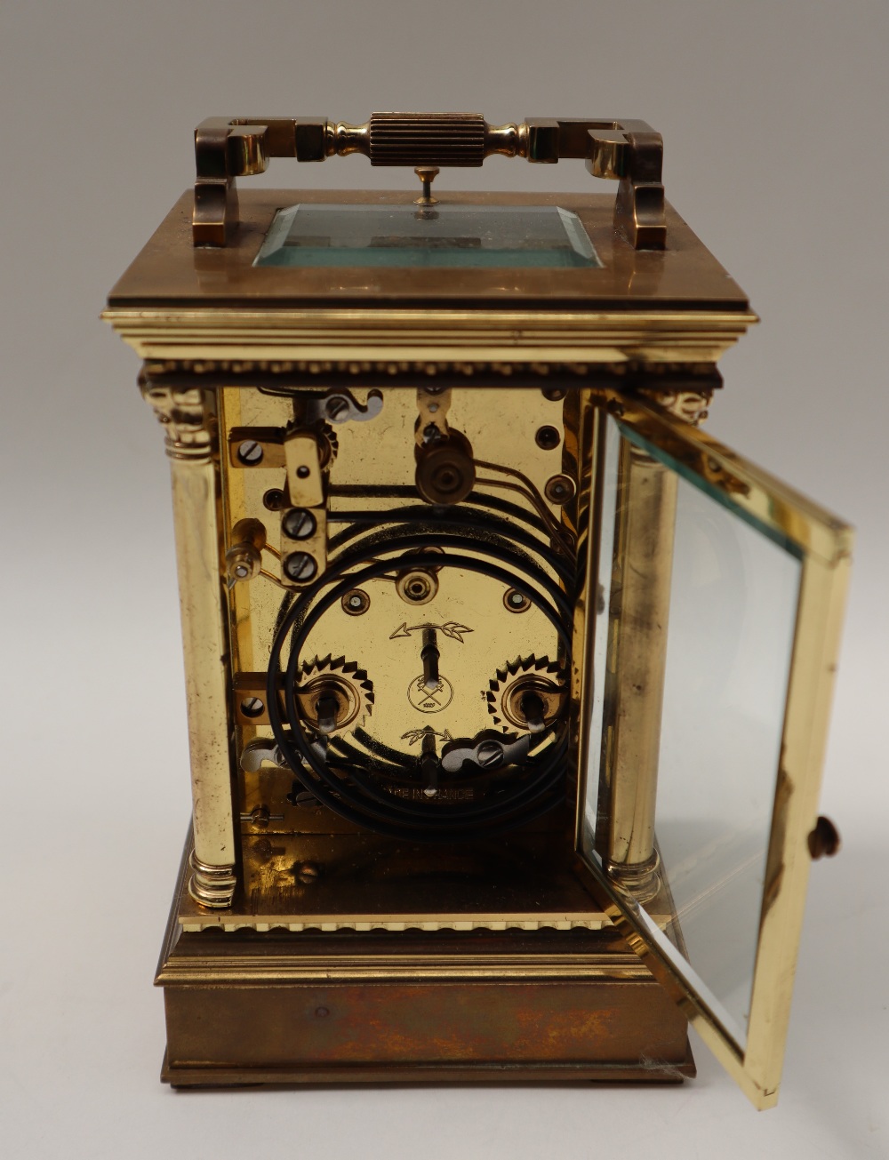 A 20th century brass cased carriage clock, with a circular dial with Roman numerals and alarm dial, - Image 4 of 7