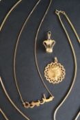 An 18ct gold pendant with an Egyptian head together with three 18ct gold chain and an 18ct gold