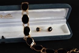 A 9ct gold onyx set bracelet, 19cm long together with a pair of matching earrings, approximately 26.