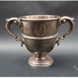 A white metal twin handled trophy cup,