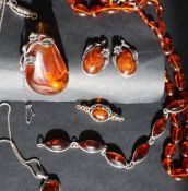An amber necklace together with an amber pendant, a pair of amber earrings,