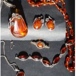 An amber necklace together with an amber pendant, a pair of amber earrings,