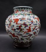A Chinese polychrome porcelain vase painted with bats in flight amongst clouds,