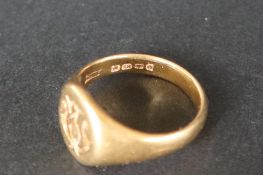 An 18ct yellow gold signet ring, the oval face initialled, size O, approximately 8.