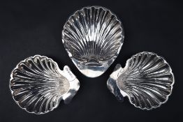 A pair of Edward VII silver shell dishes, Birmingham, 1906, together with another silver shell dish,