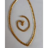 A 22ct yellow gold V shaped necklace, 45cm long together with a 22ct gold circular link bracelet,