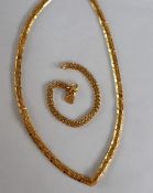 A 22ct yellow gold V shaped necklace, 45cm long together with a 22ct gold circular link bracelet,