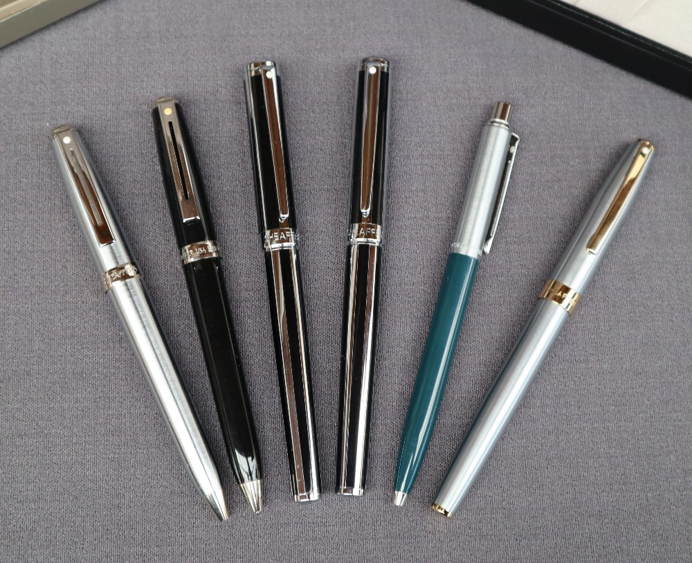 Two Sheaffer black and chrome fountain pen together with another Sheaffer fountain pen and three