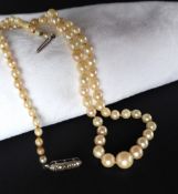 A pearl necklace set with eighty-nine graduated pearls to a sterling silver marcasite set clasp,