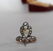 A diamond and pearl dress ring of looping form set with a central pearl and old round and cushion