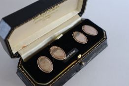 A cased pair of silver cufflinks,